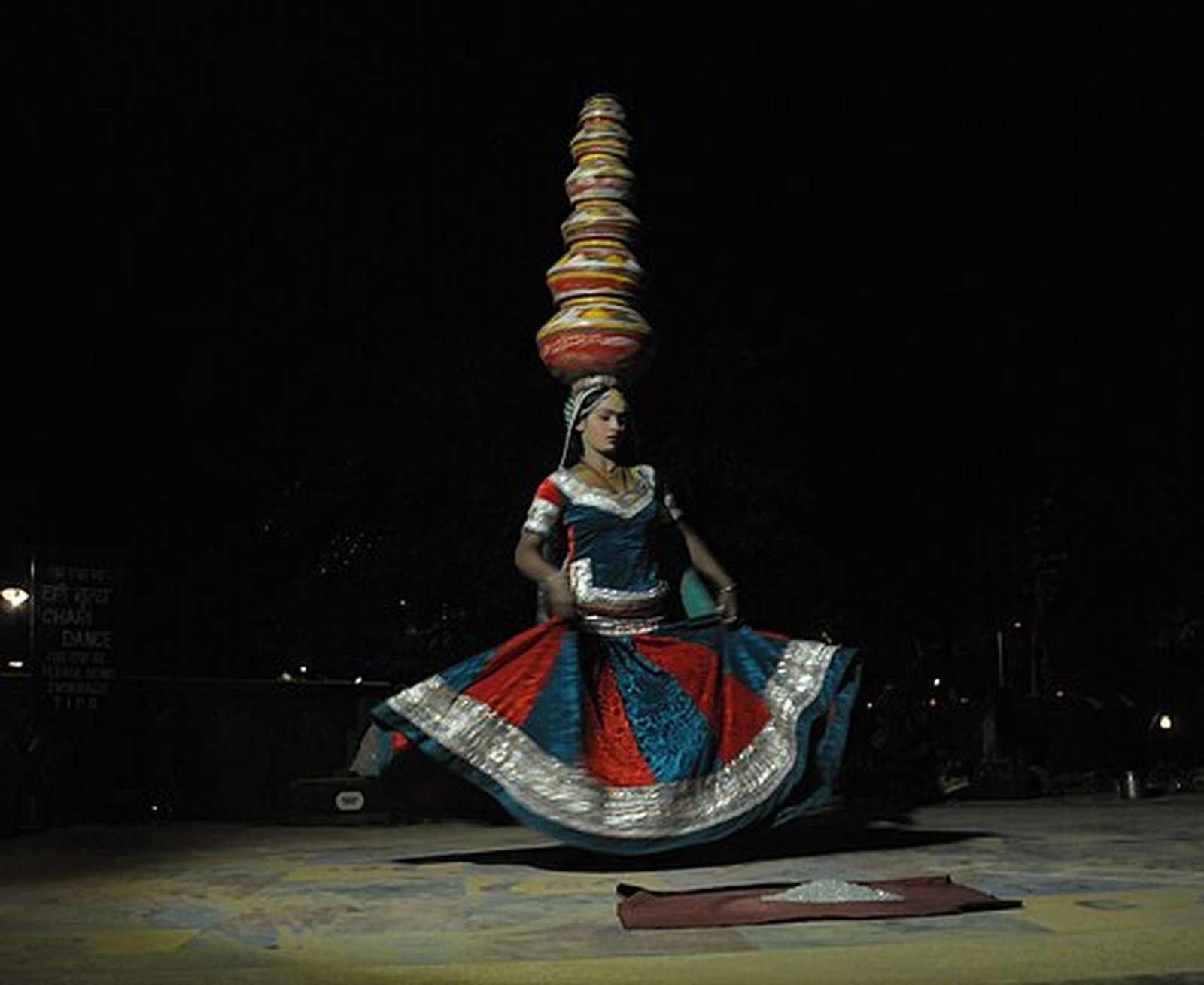 Bhavai dancer balancing stacked brass pots on her head