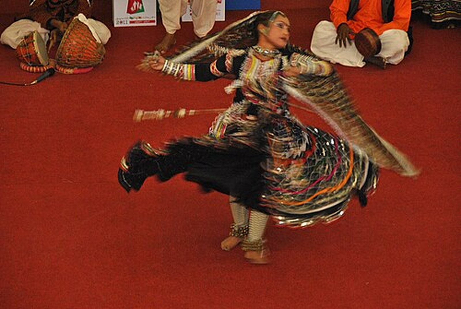 Kalbeliya dancer spinning in a black embroidered skirt