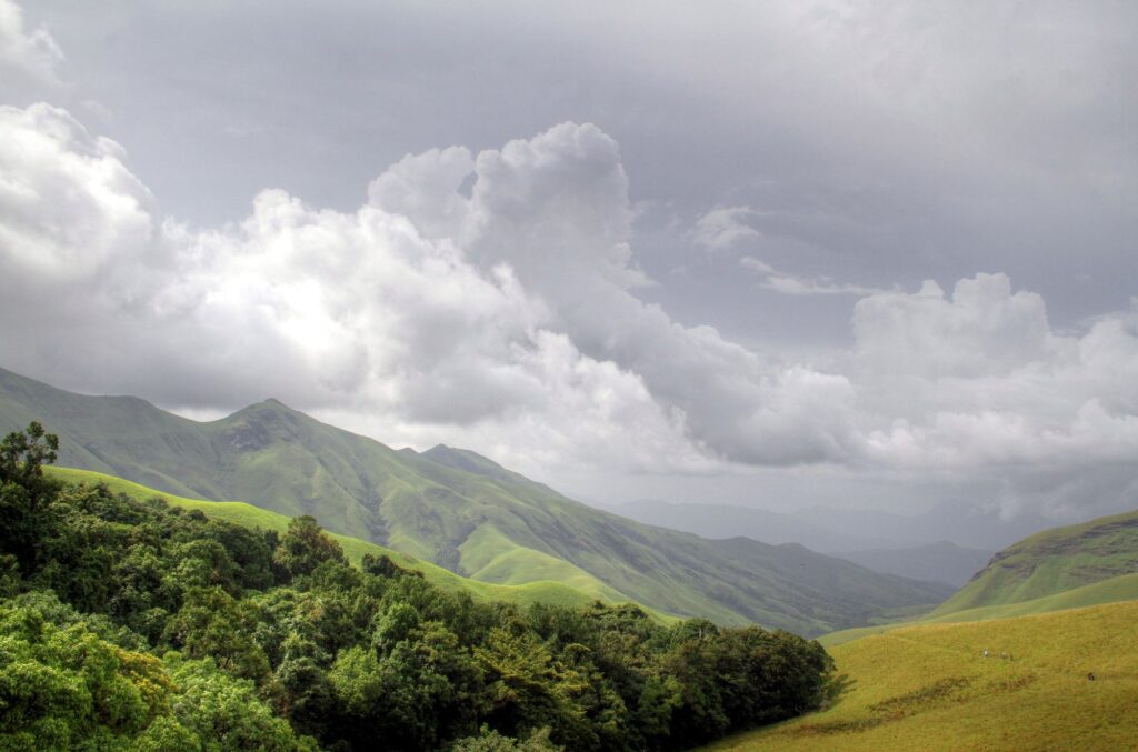 Rolling shola grasslands and clouds at Kudremukh National Park