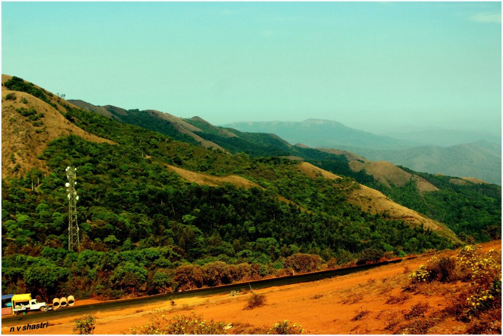 Winding road below the green peaks of Mullayanagiri in Chikmagalur