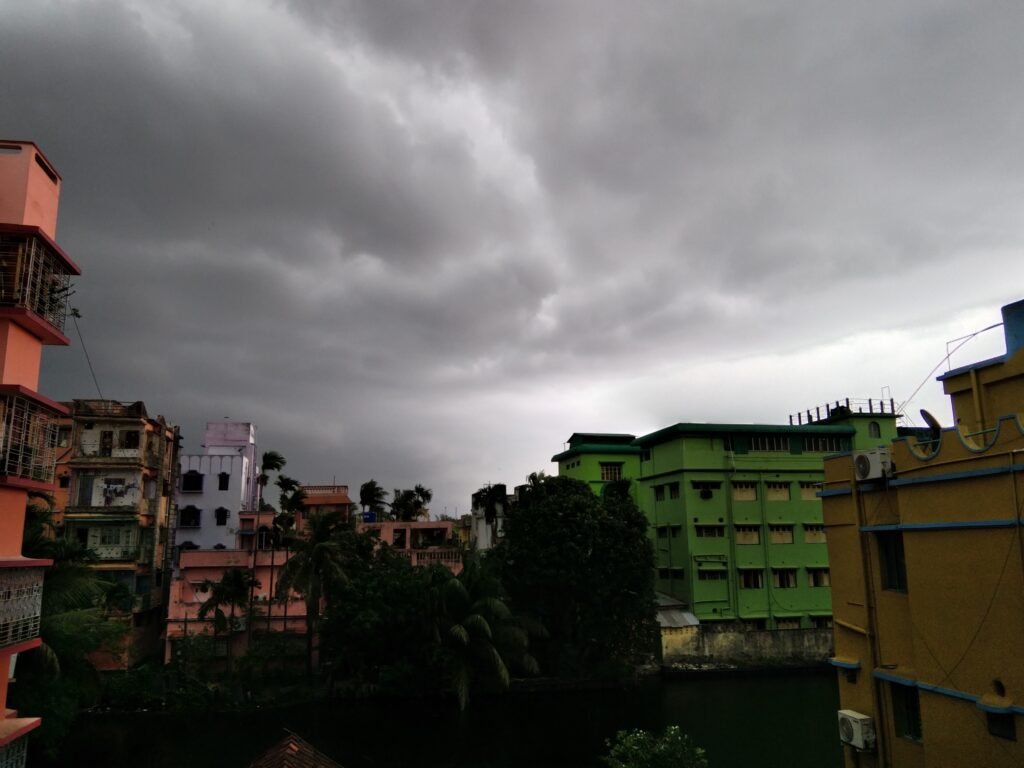 Dark pre-monsoon clouds gathering over rooftops in Howrah