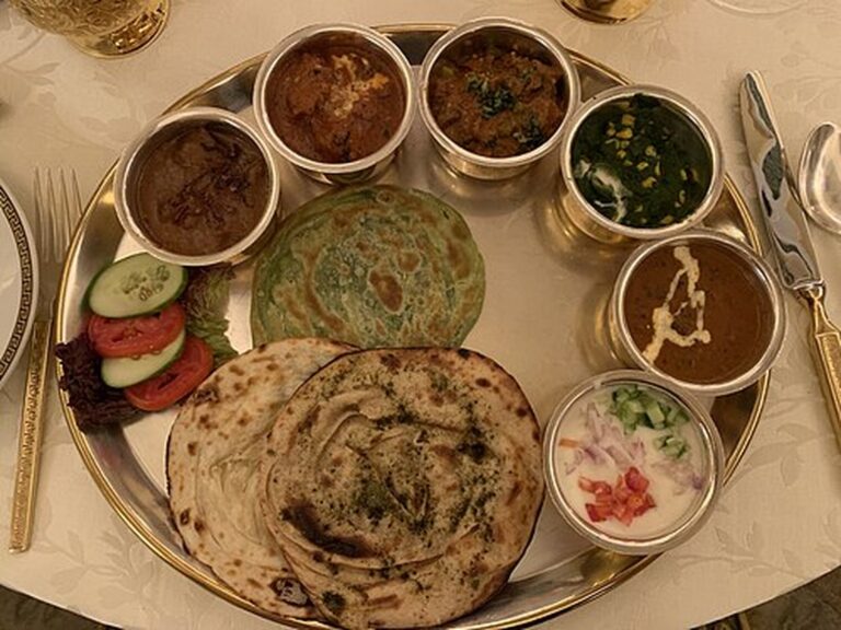 Royal Rajasthani thali with curries, raita and layered paratha