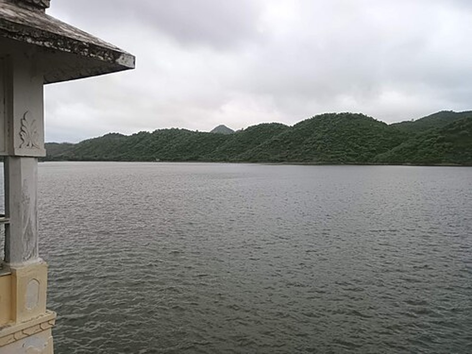 Badi Lake (Jiyan Sagar) seen from a stone pavilion with green Aravalli hills behind