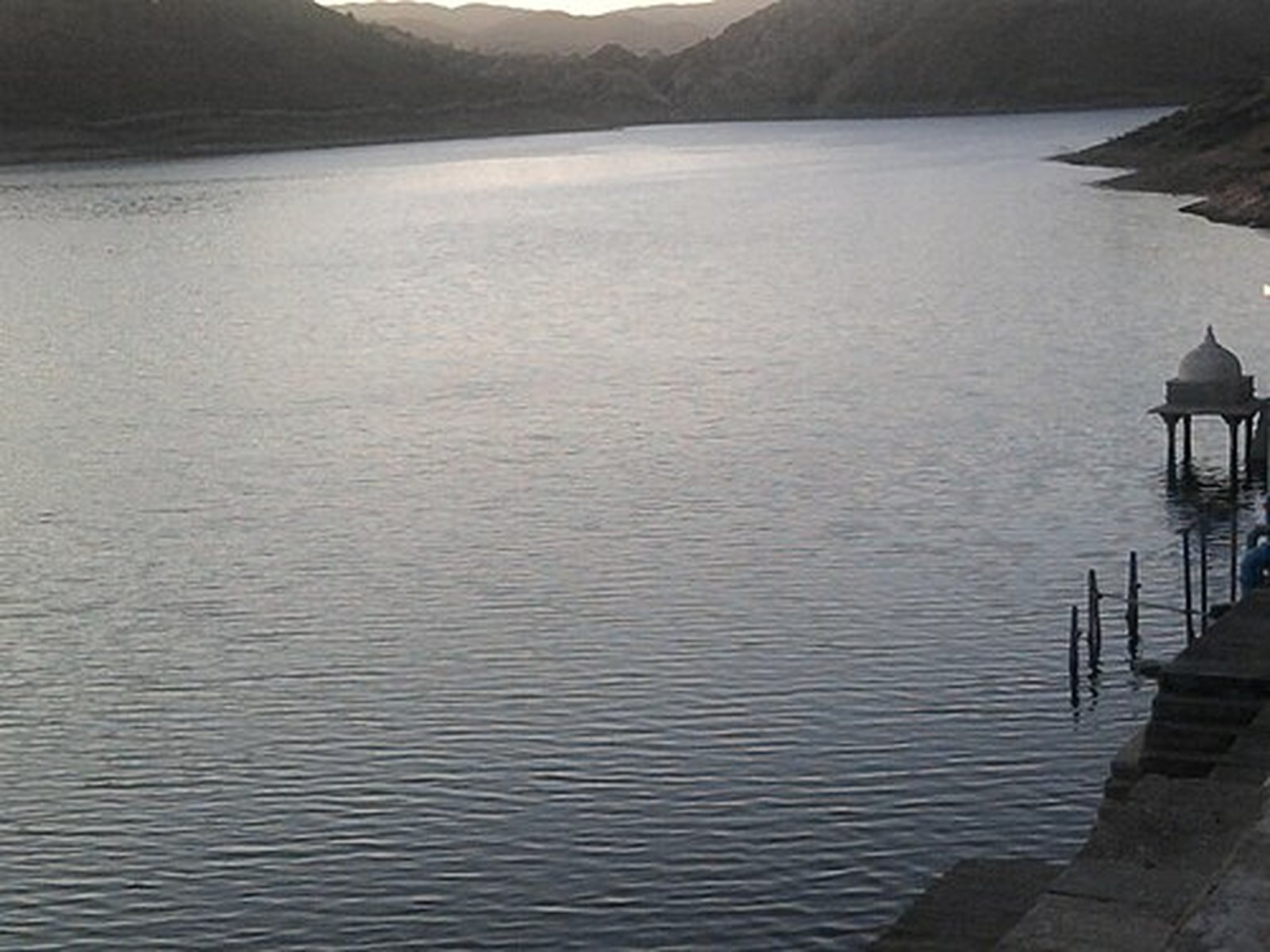 Calm waters of Badi Lake framed by forested hills north of Udaipur