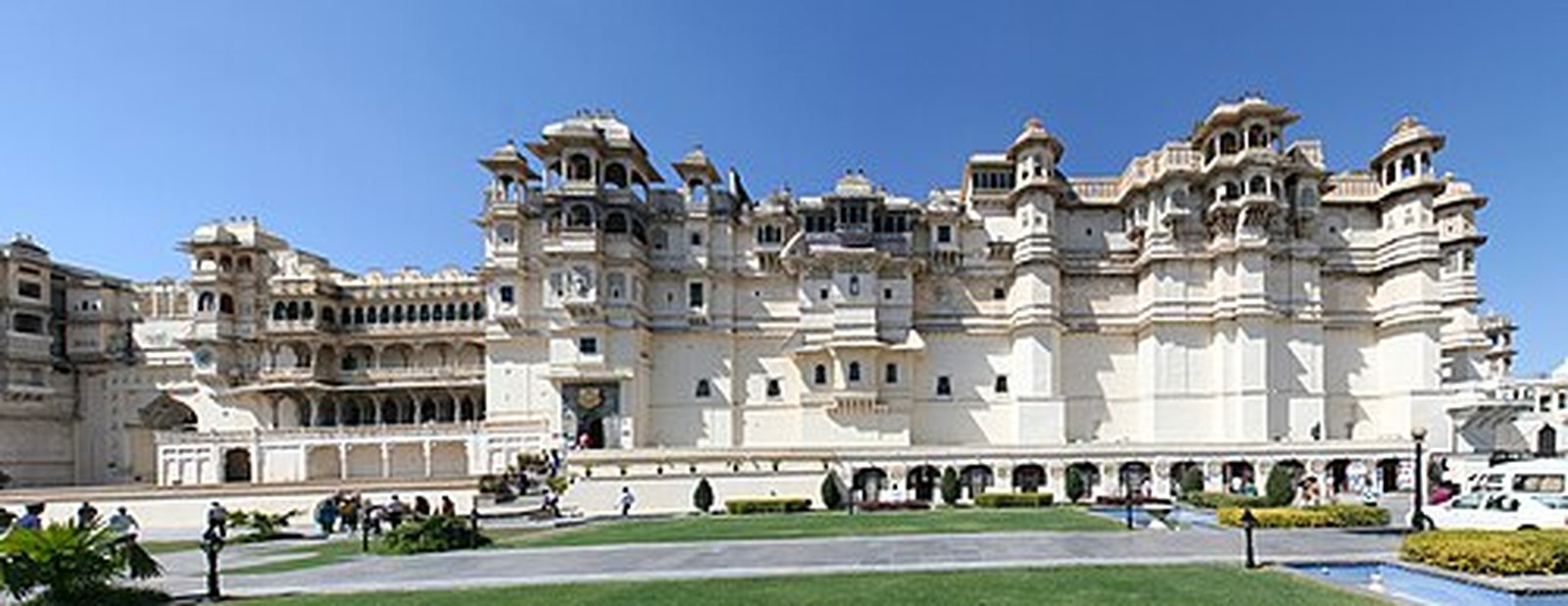 White facade and domed towers of the City Palace, Udaipur, seen from the main courtyard