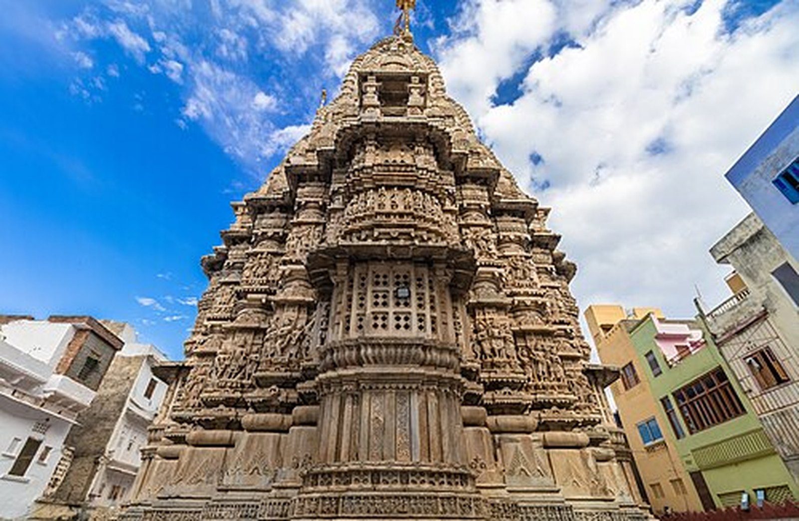 The towering carved shikhara of Jagdish Temple against a blue sky in Udaipur old city