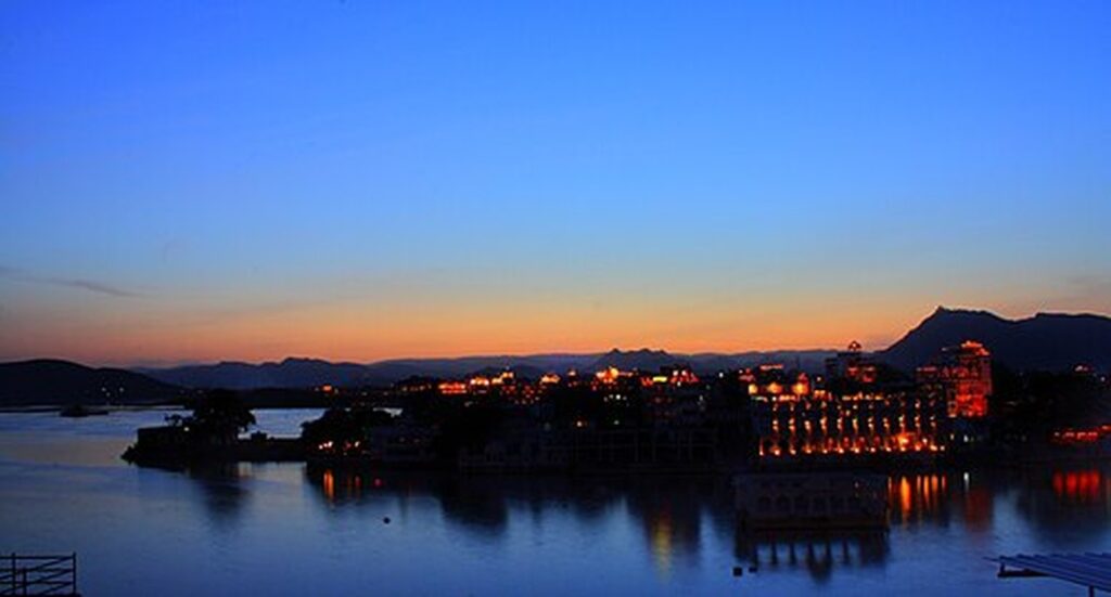 Blue-hour sunset over Lake Pichola with the illuminated palaces of Udaipur