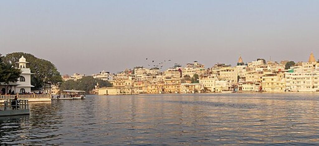 Golden evening light over the ghats and old city on Lake Pichola, Udaipur