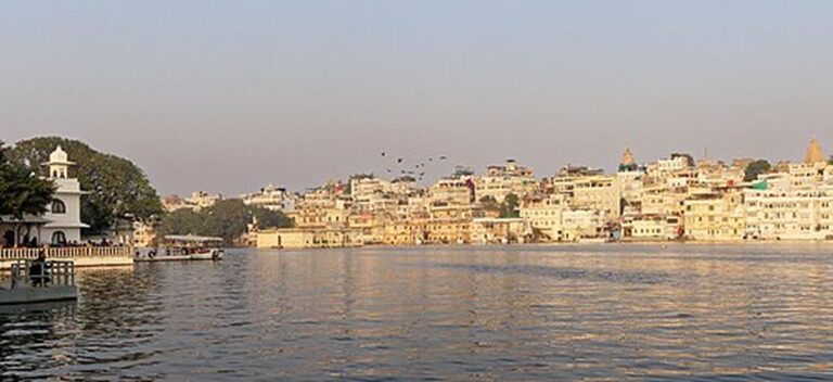 Golden evening light over the ghats and old city on Lake Pichola, Udaipur