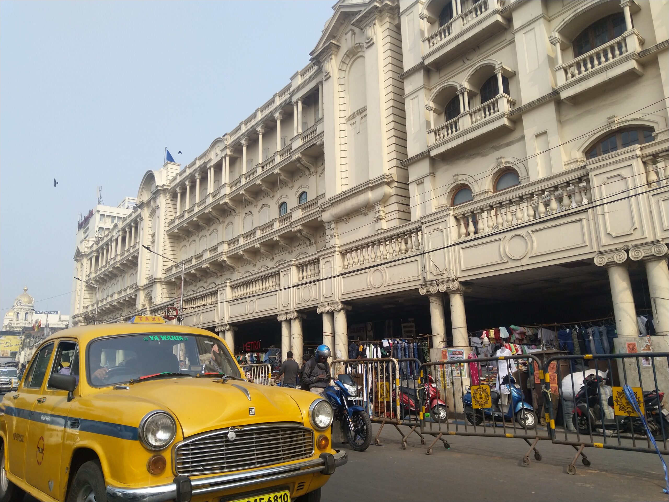 A yellow Ambassador taxi at Esplanade, Kolkata